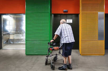 Old man in front of the hospital lift - A Photographic Art Artwork by Stefan Zausinger