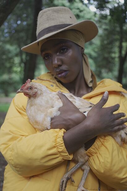 Bakhita with Chicken - A Photographic Art Artwork by Nyokabi kimari
