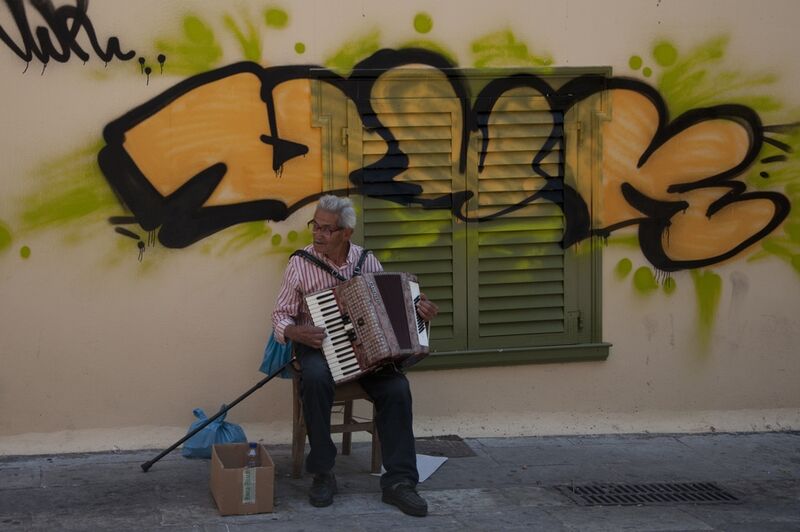 Street musician in greece - a Photographic Art by Andrea Mattia